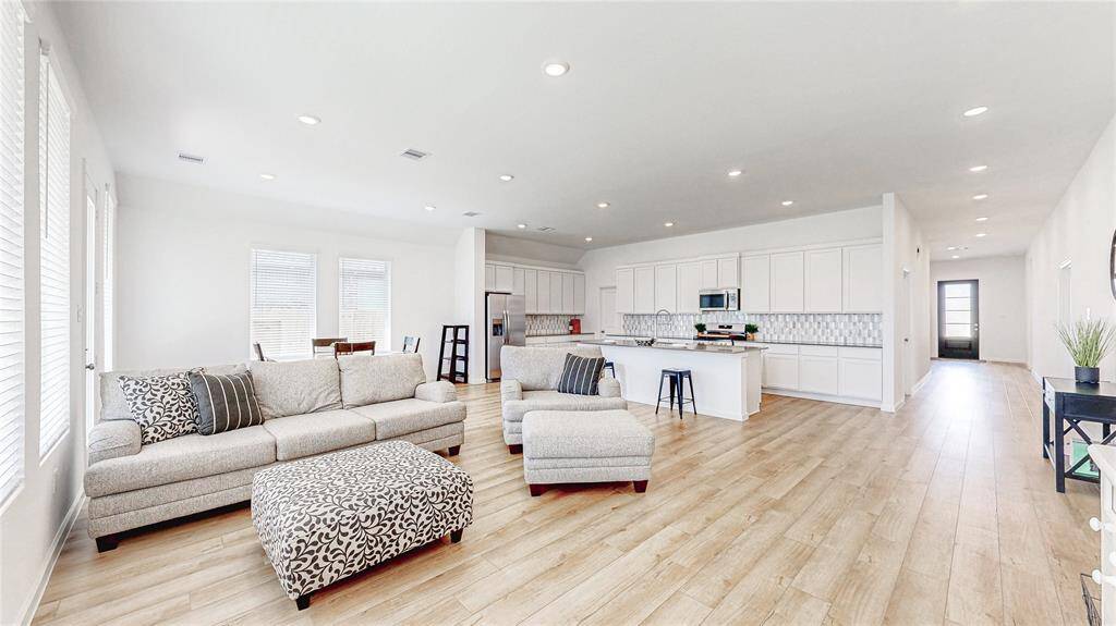 Seamlessly connected, the kitchen flows into the open living and dining areas.