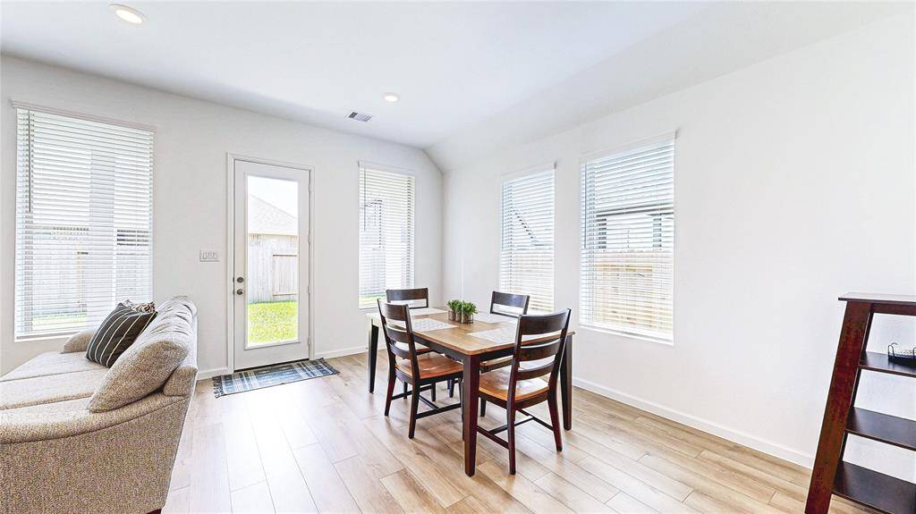 Bright and inviting dining area with ample natural light, perfect for family gatherings and entertaining.