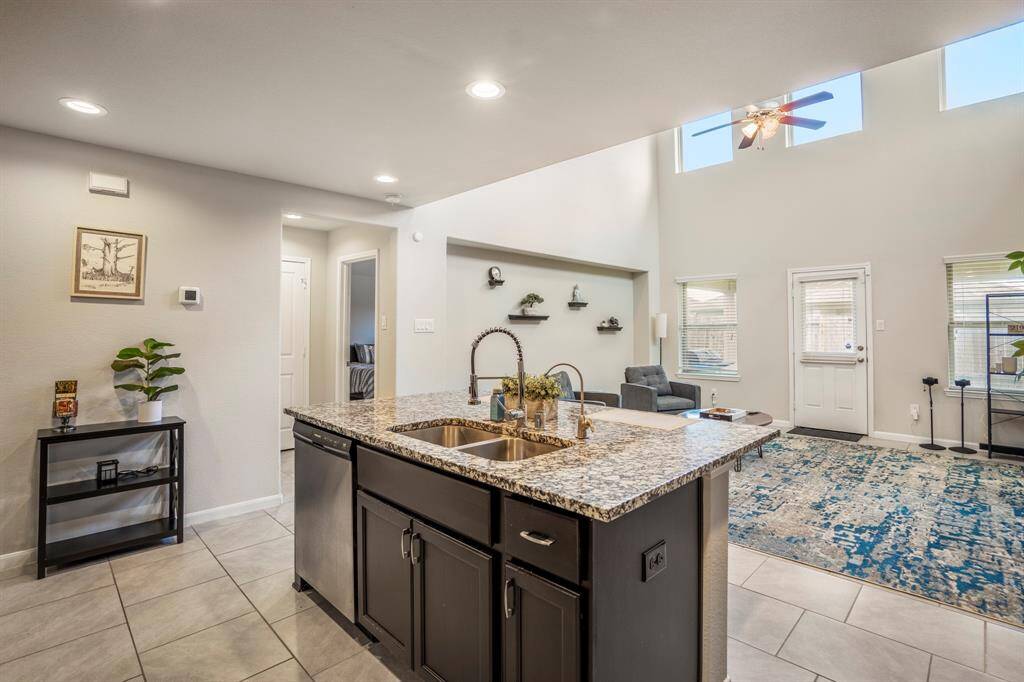 Dual sinks in the island with a dishwasher and space to store your cleaning supplies.