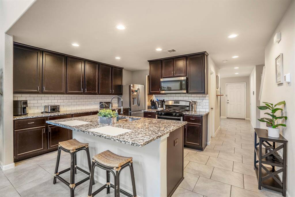 The kitchen has plenty of counter top space as well as this island which offers additional storage.