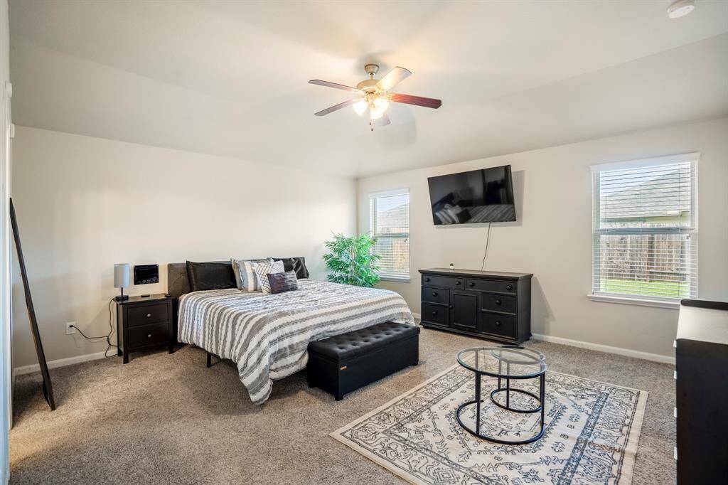 The large primary bedroom has two large windows and offers lots of light.