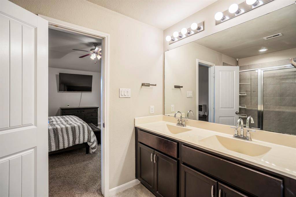 The bathroom has plenty of cabinet storage area under the sinks.