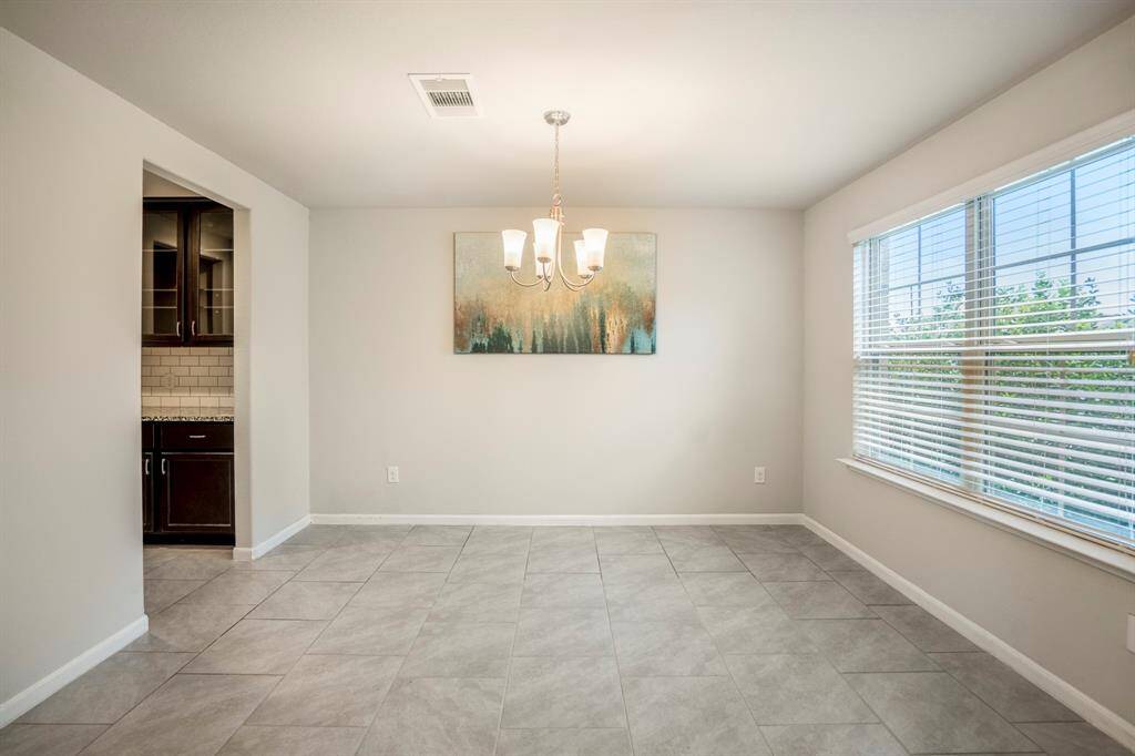 The formal dining room has plenty of space for your entertainment needs with lots of windows that offer natural light.