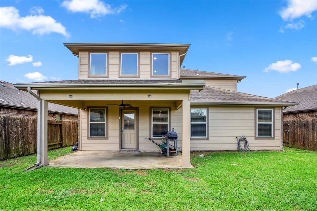 A nice size covered patio with plenty of grassy area surrounding the backyard.