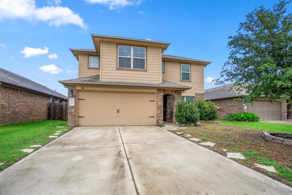 The home has a 2 car attached garage and a long driveway.