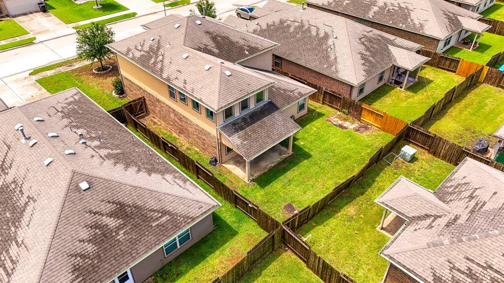 An aerial view of the home in location to its neighbors.