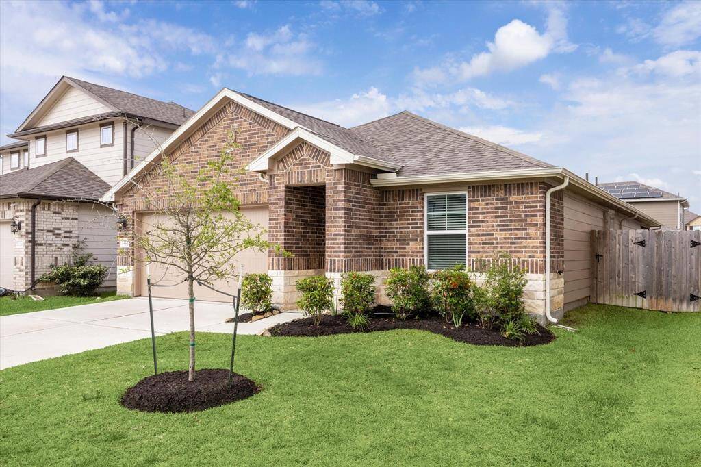 Nicely landscaped with rain gutters and sprinkler system