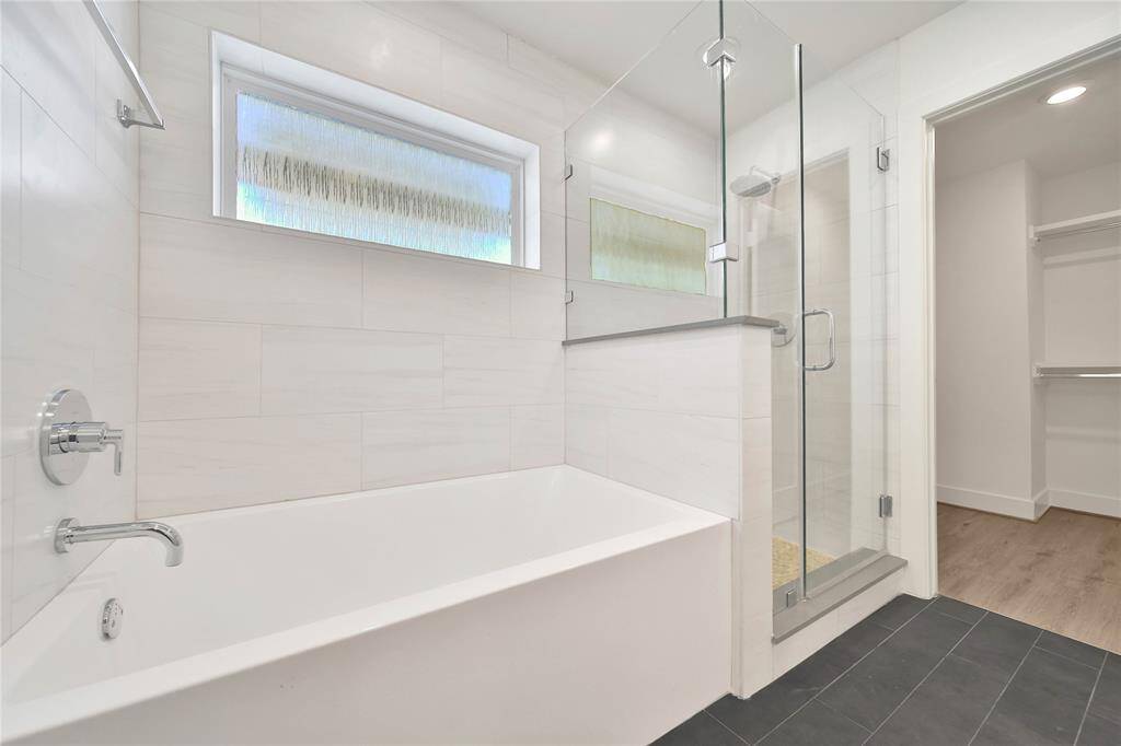 Primary bathroom features a separate bathtub and shower.