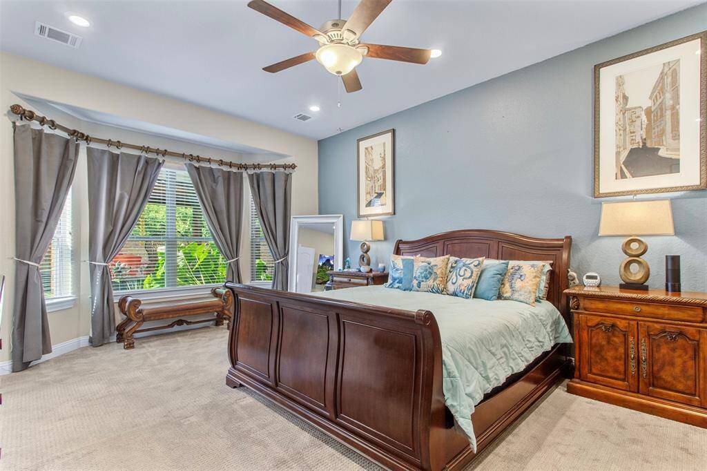 Spacious Primary Bedroom with bay window overlooking the beautiful backyard.