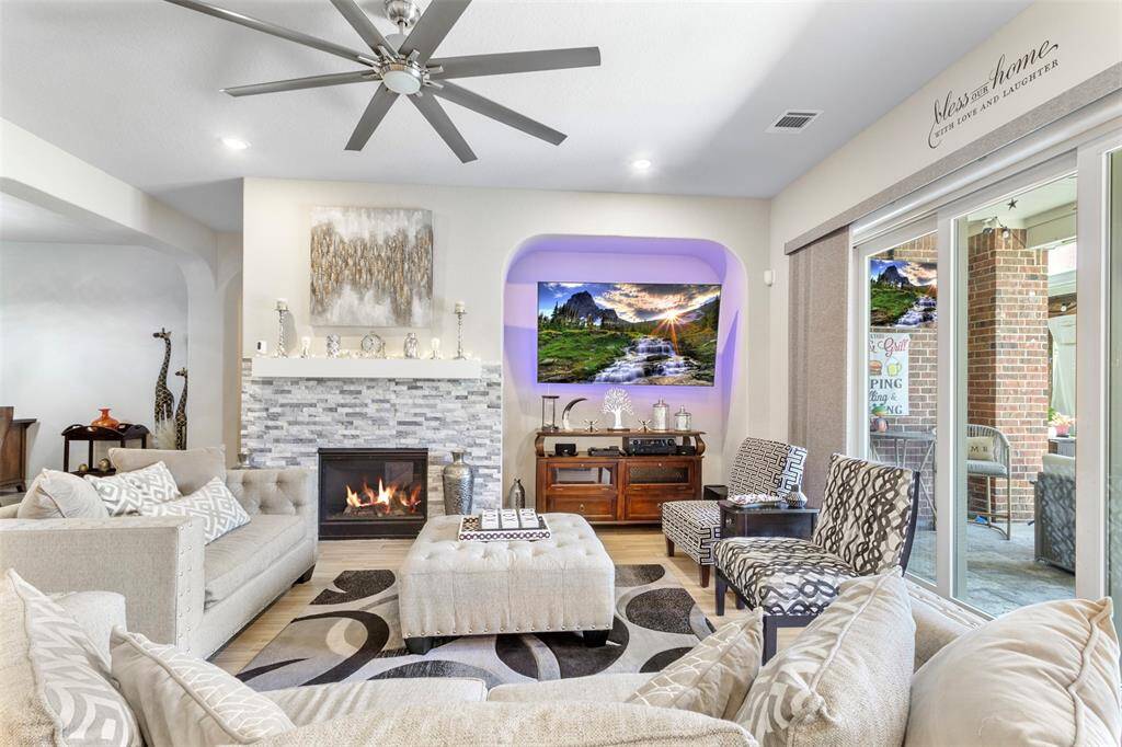 Gorgeous fireplace for that cozy feel in the winter and that large ceiling fan is sure to keep you cool on these hot summer days.