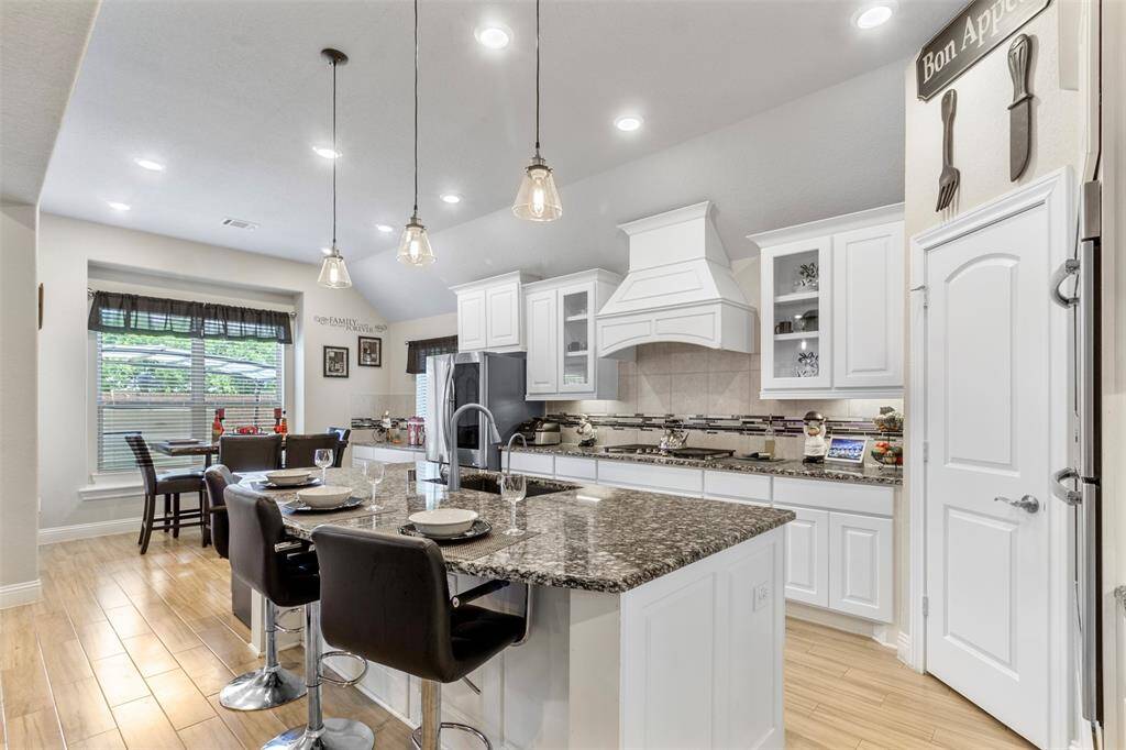 This stunning kitchen offers plenty of counter space with granite counters and plenty of cabinets.