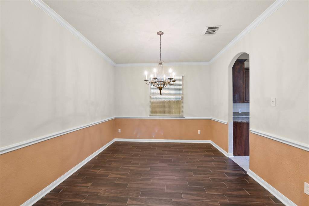 Formal dining room with chair rail and easy access to the kitchen.