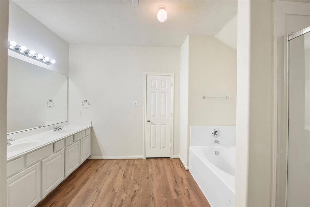 Primary bath has separate tub and shower.
