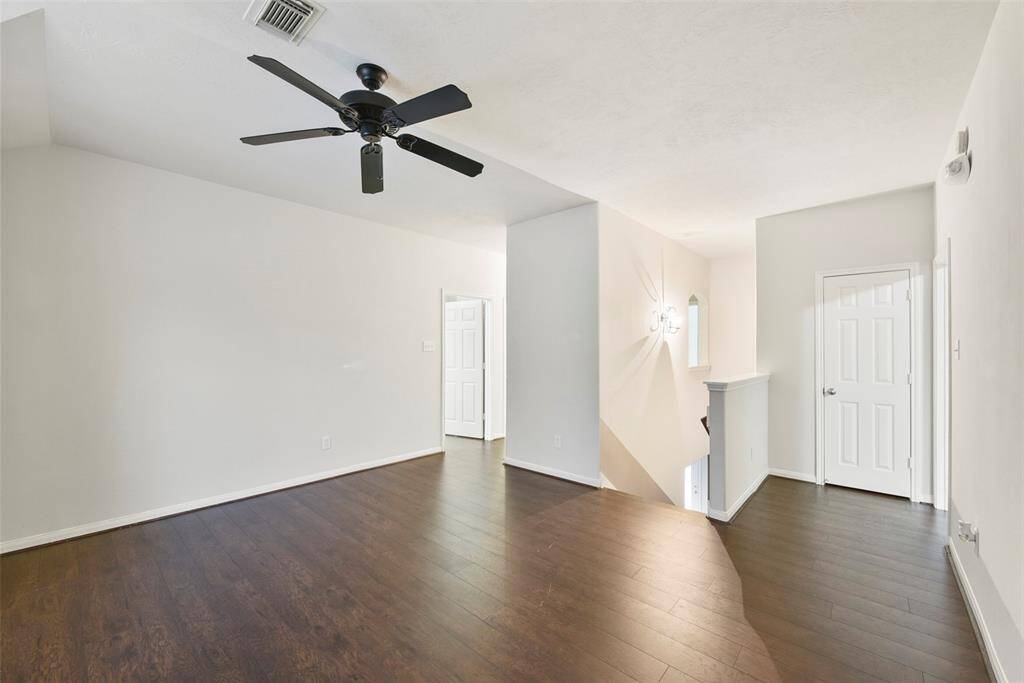 Game Room at the top of the stairs.  It divides the space between the primary bedroom and the secondary bedrooms.