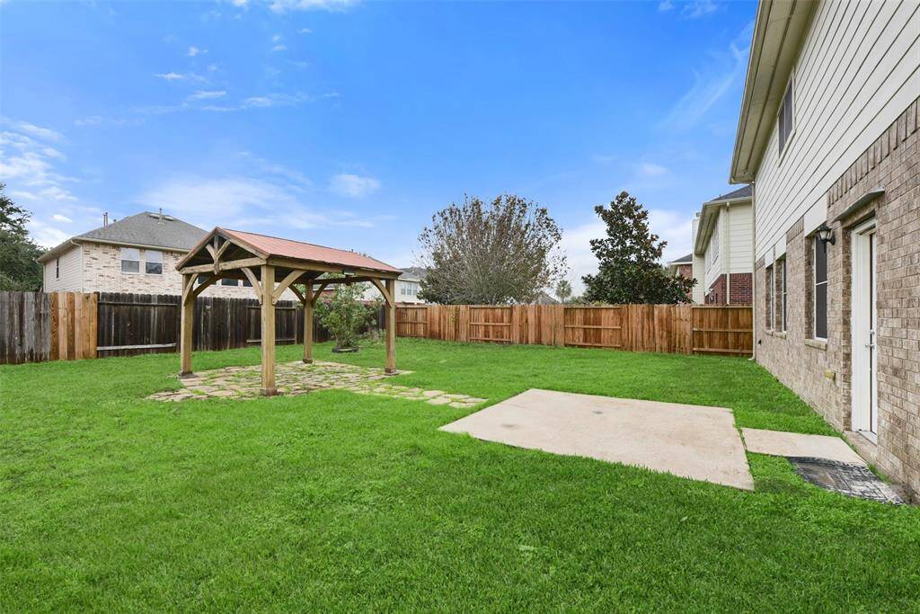 The backyard has a covered space that would make a great place to sit with your morning coffee.