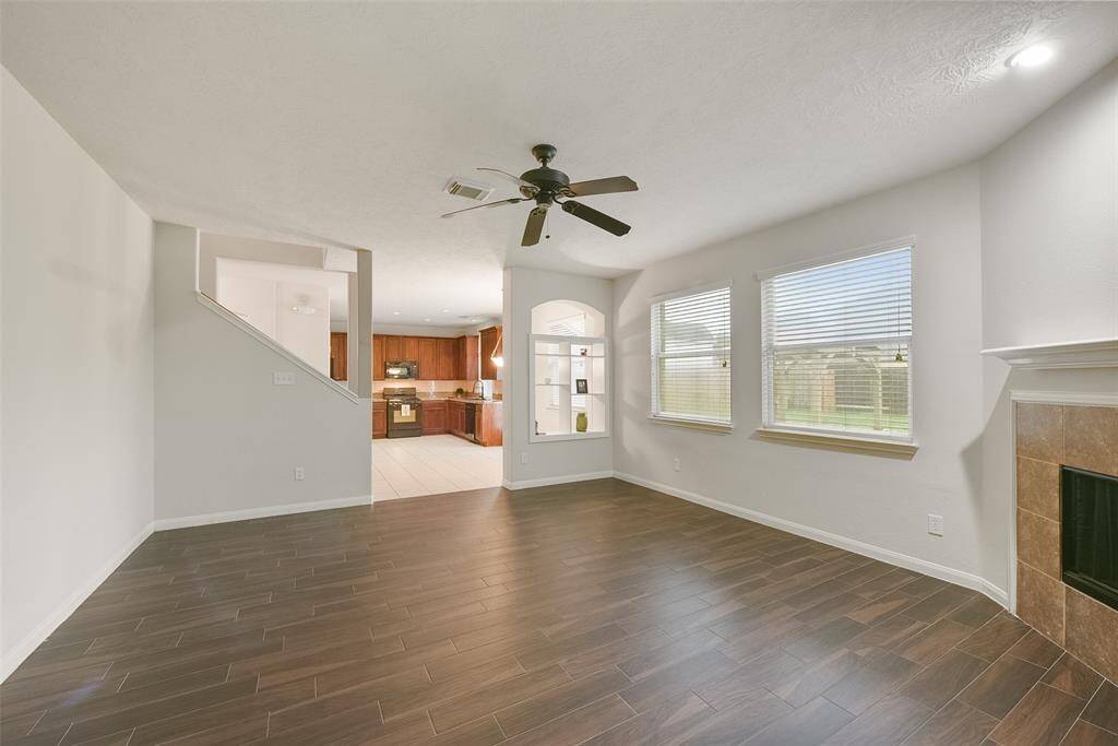The view from the family room to the kitchen area with a view to the large backyard also. Display your favorite keepsakes or books on the shelf between the family room and breakfast room.