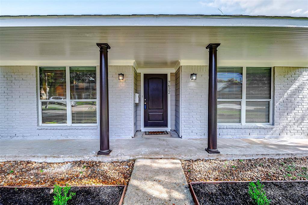 A charming, landscaped pathway leads to the welcoming front porch that spans the width of the home—perfect for your favorite outdoor seating setup. Flanked by classic coach lights, the entry offers a cozy first impression.