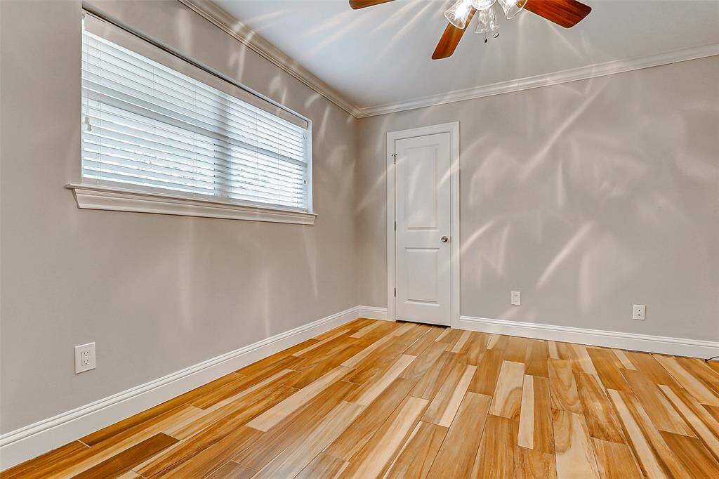 The second guest bedroom offers many of the same thoughtful features as the first, with the added distinction of an extra-wide window that begins halfway up the wall and extends all the way to the ceiling, flooding the room with natural light.