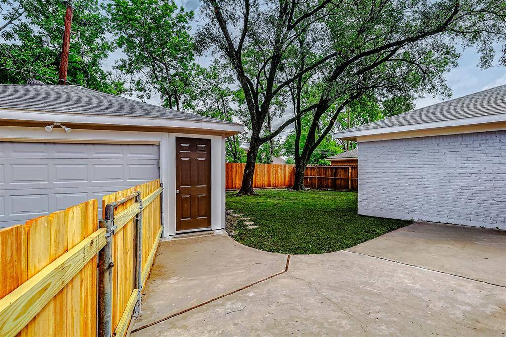 The back patio features a convenient walkway leading directly to the garage door, allowing easy access without the need to go through the exterior gate.