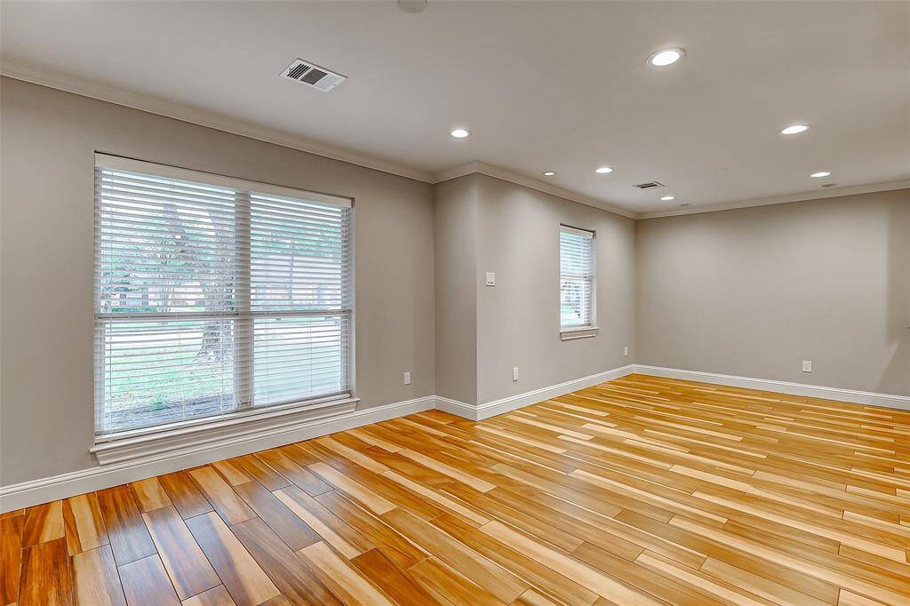 Generously sized dining areas provide the perfect setting for hosting gatherings, both large and small. A stunning floor-to-ceiling window frames views of the front yard, bringing in natural light and a touch of charm.