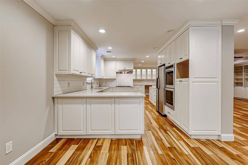 Soothing paint tones, custom cabinetry, and wood-look tile flooring flow seamlessly throughout this beautifully updated home. At its heart lies the stylish, modern kitchen—perfectly designed for both daily living and entertaining.