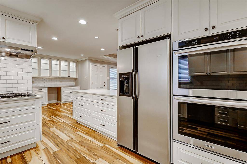 Step into your upgraded kitchen, complete with abundant cabinetry, generous drawer space, double ovens, a gas cooktop with a complementing vent hood, and more—offering both style and function for the home chef.