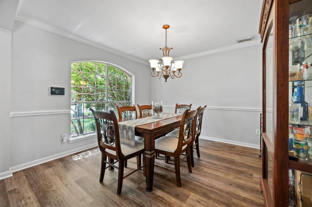 Large dining room with chair rail and crown molding