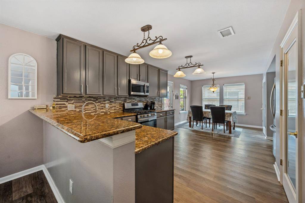 Kitchen with breakfast room in background