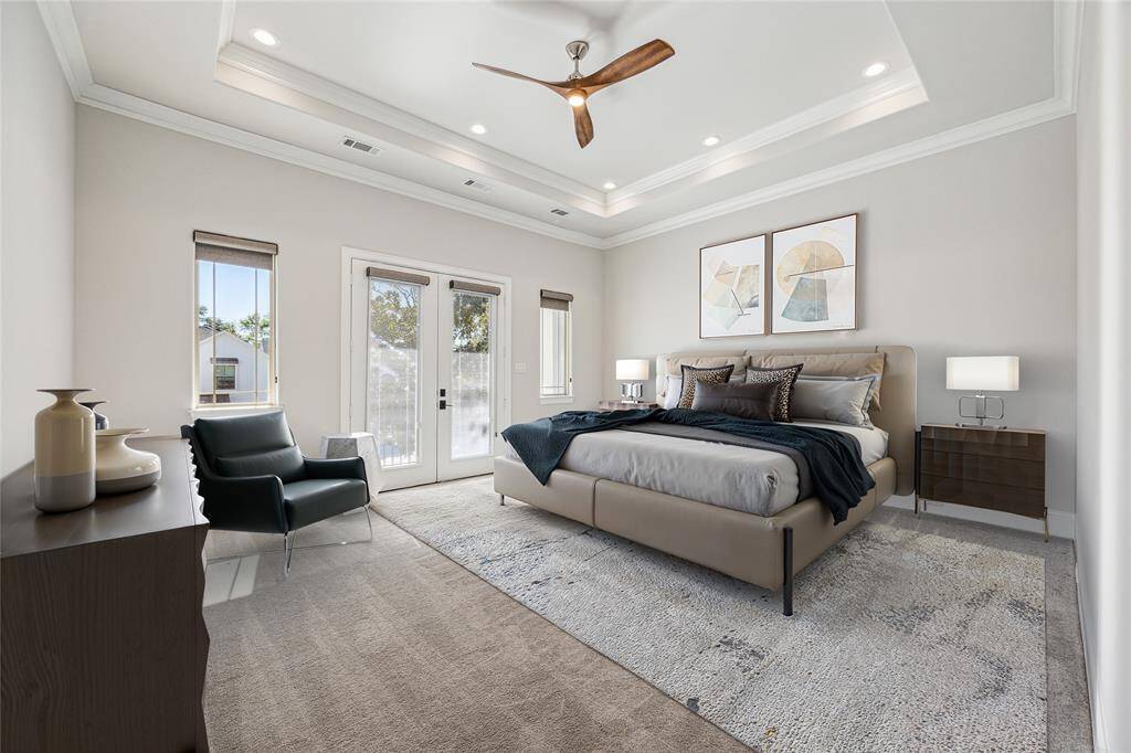 **Virtually Staged** A serene primary retreat with a tray ceiling, modern ceiling fan, recessed lighting, and plush carpet, along with French doors leading to a private balcony.