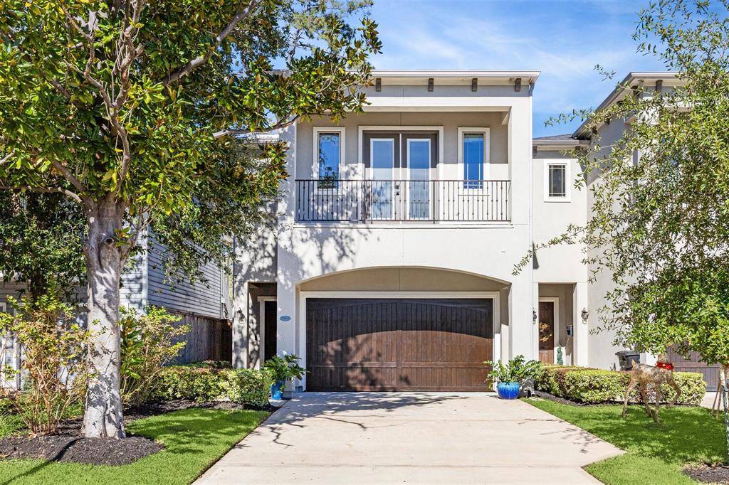 Stunning modern elevation with clean lines, mature landscaping, and a welcoming covered front porch.