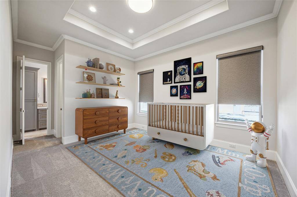 **Virtually Staged** Secondary bedroom featuring tray ceiling, recessed lighting, ceiling fan, crown molding, plush carpeting, and access to a secondary bathroom.