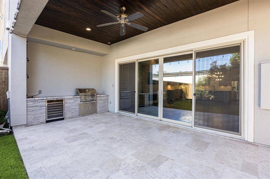 A closer view of the outdoor kitchen with its sleek stainless steel appliances, perfect for entertaining outdoors.