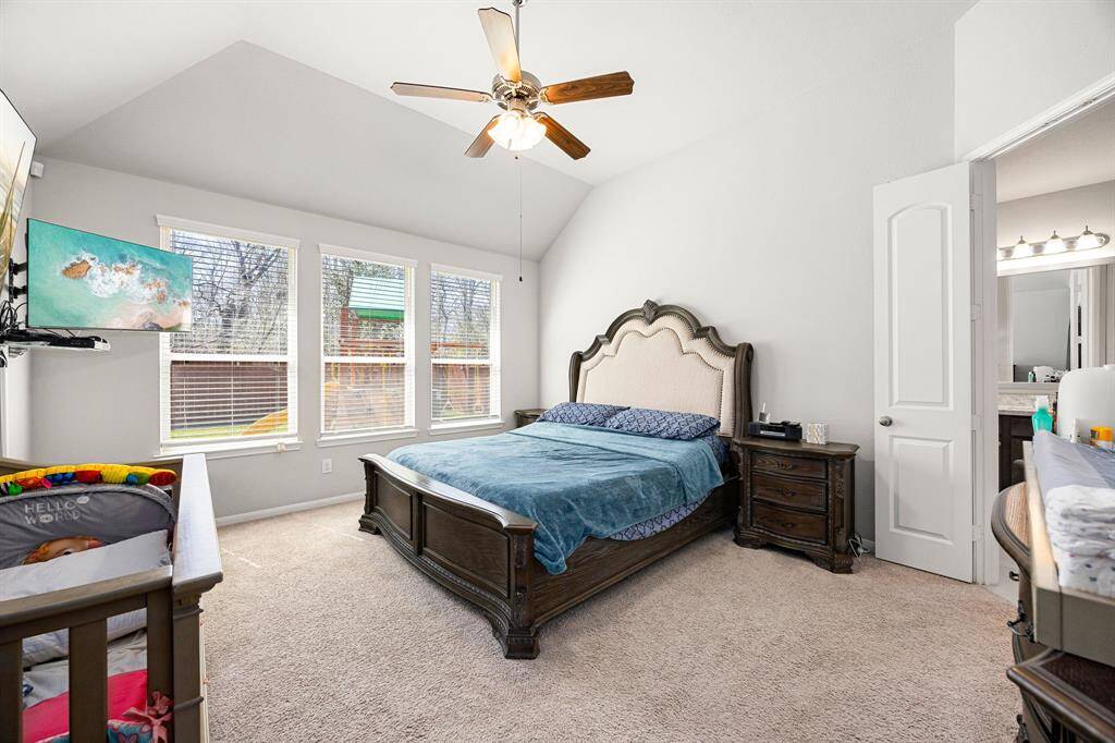 Experience the spacious comfort and abundant natural light of the primary bedroom.
