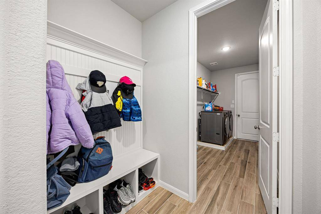Welcome home to a well-organized mudroom and laundry space, perfect for keeping your entryway tidy.