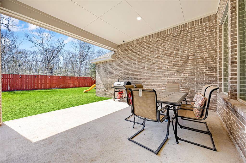 Enjoy hosting gatherings on the spacious covered patio, perfect for outdoor entertaining.