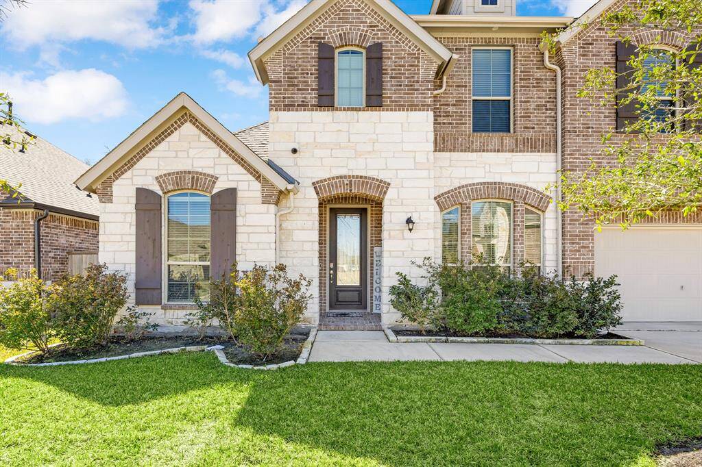 Welcome to your serene retreat, featuring stunning landscaping and the convenience of a sprinkler system.
