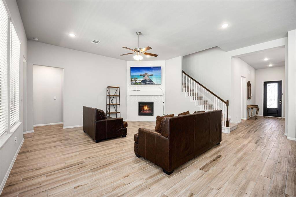 Unwind in the great room, featuring a cozy fireplace with a maple mantel and elegant tile surround.
