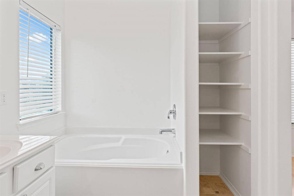 Primary bath has linen storage
