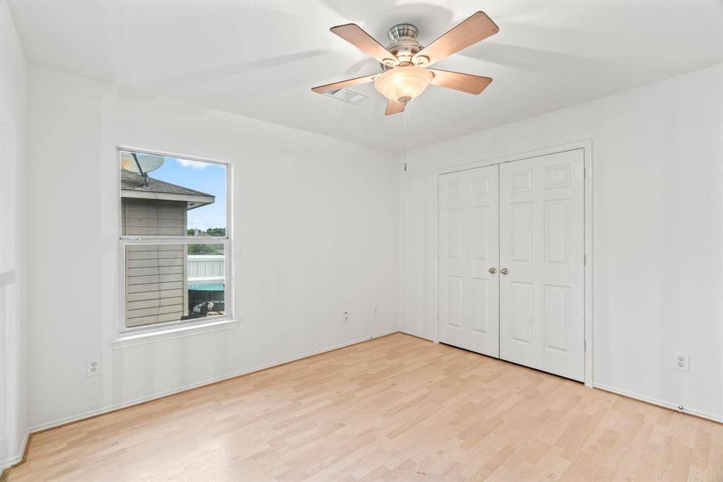 Another secondary bedroom with fan and closet