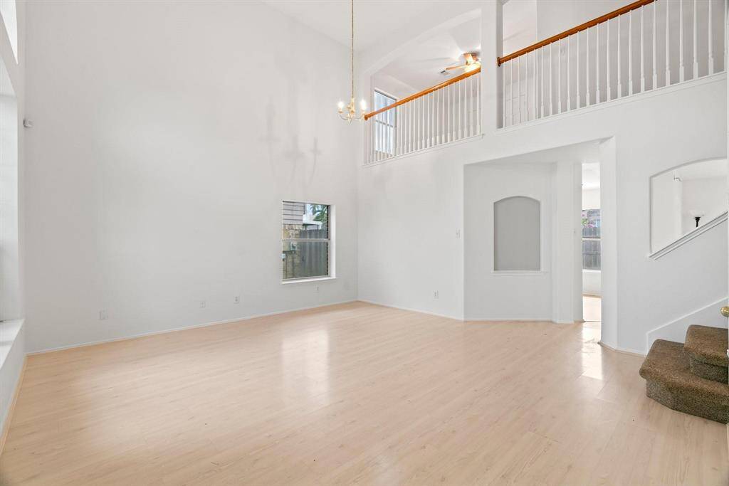 High soaring ceilings. Stairwell leading to bedrooms and game room