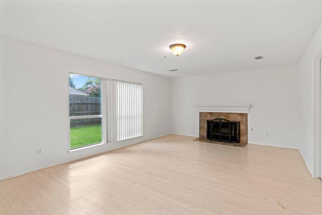Spacious family room features a gas log fireplace