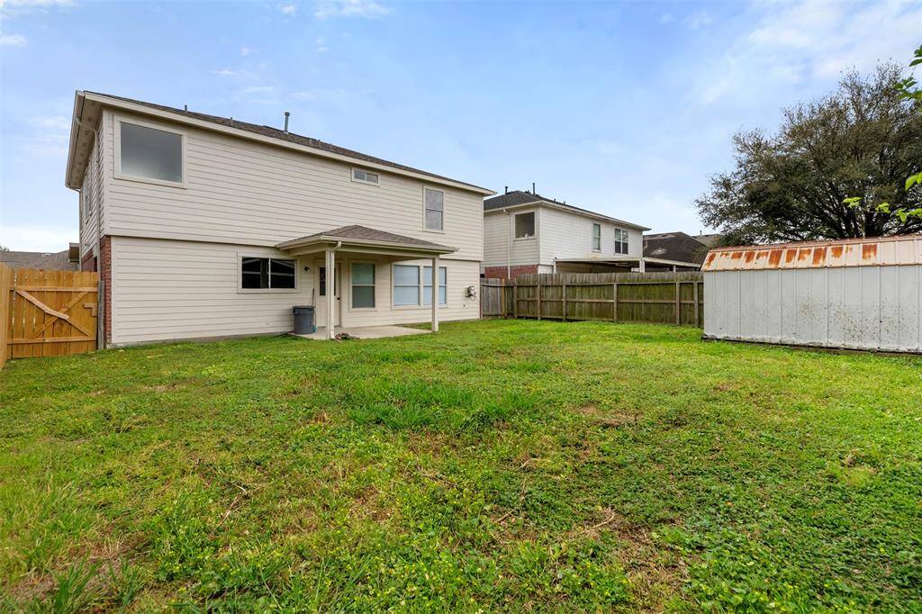 Backyard with storage shed fully fenced