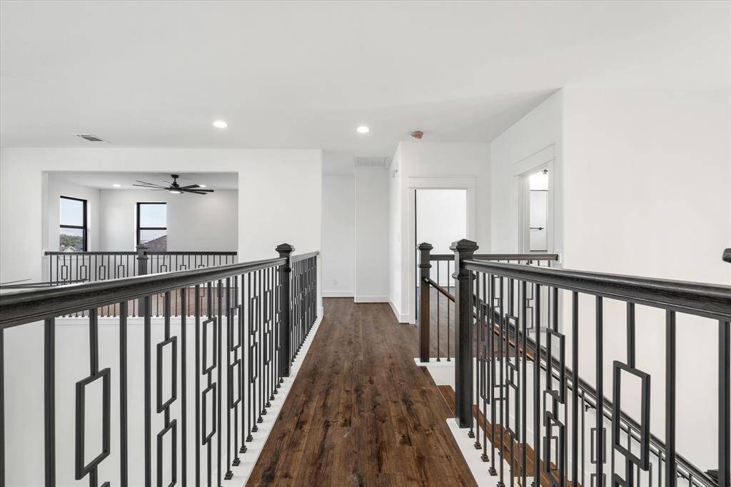 The hallway, which leads to the upstair bedrooms, is finished with wood-look tile flooring that extends seamlessly throughout the entire home.