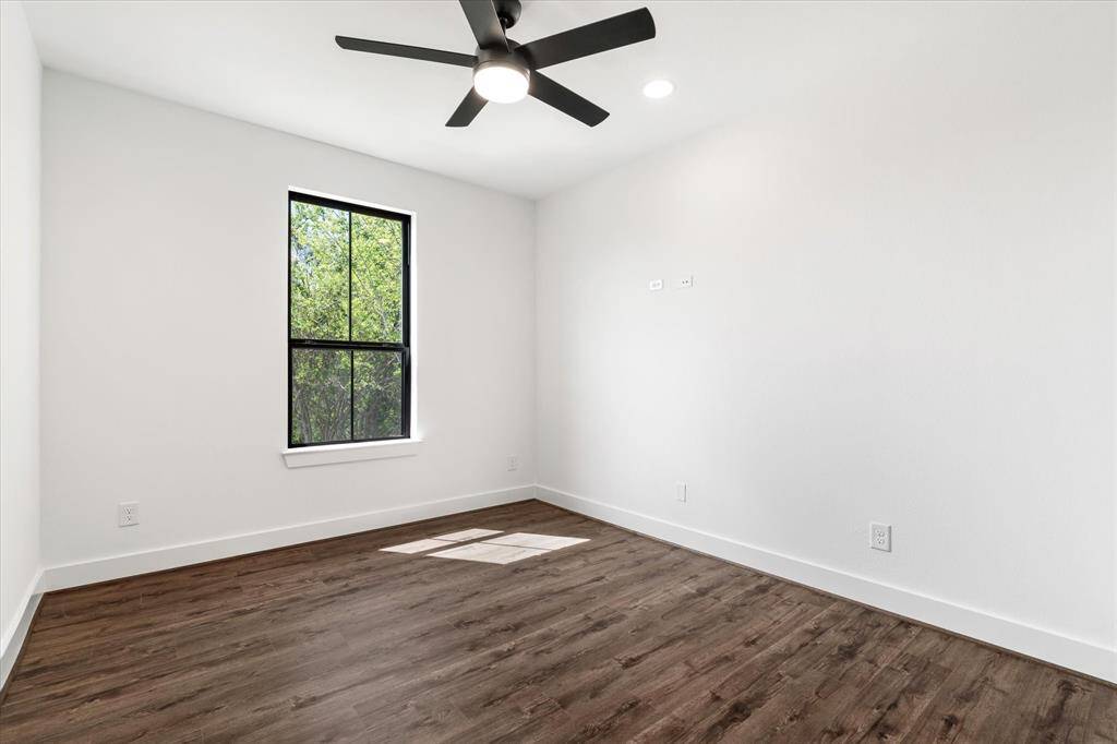 Bedroom 3! Showcasing a closet, ceiling fan & wood look tile flooring.