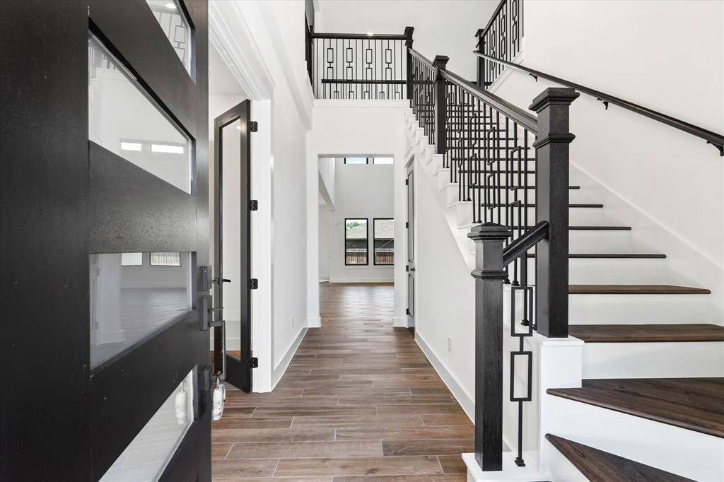 Step into elegance through the striking modern front door and be welcomed by a stunning two-story entryway.