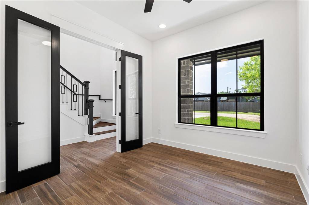 This versatile space, features elegant double glass doors and a front facing large window that fills the room with natural light. Enhanced by recessed lighting and a sleek ceiling fan, it offers a stylish and functional setting for entertaining, home office, flex space or even a formal dinning area.