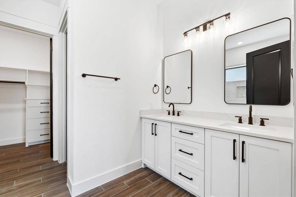 The en-suite bathroom features 2 sinks, modern fixtures and quartz countertop. Also has access to your walk in closet.