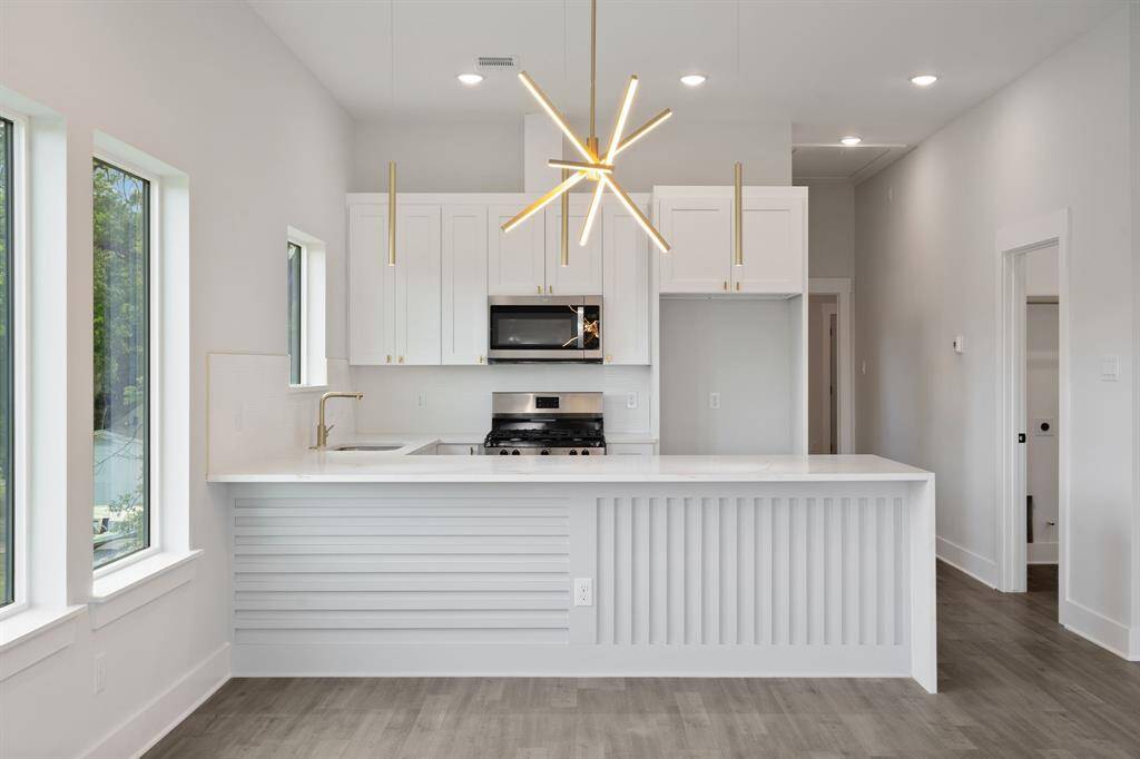 Kitchen Area With Waterfall Island And Modern Finishes.