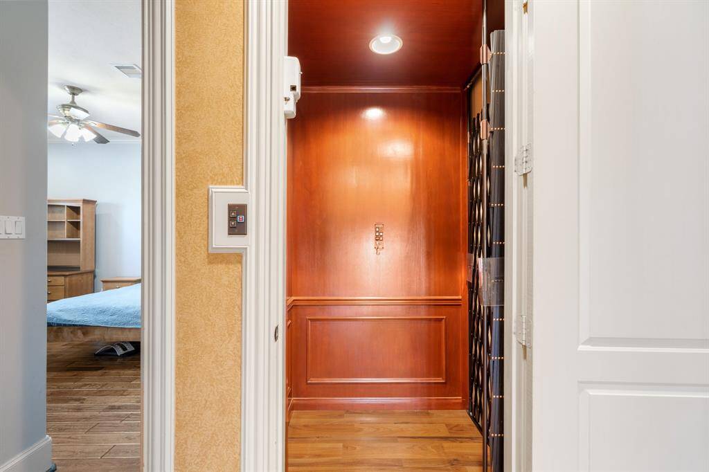 Convenient elevator with wood paneling leads you from the first floor entertaining spaces to the 2nd floor with all of the bedrooms and game room.
