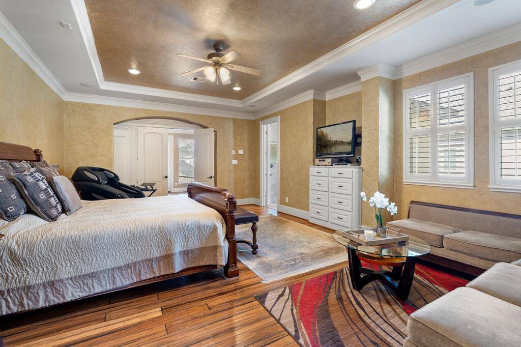 From this angle, double doors open off of the primary suite to a home office/flex room. The door on the right leads to the en-suite bathroom.